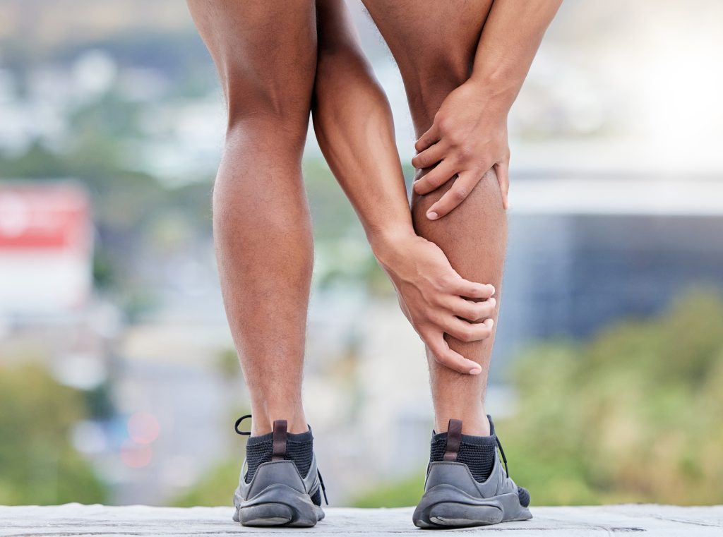 Man, fitness and legs injury on outdoor run for sports marathon, exercise emergency or wellness acc